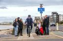Ayrshire College students Kenzie Millen; Lewis Dunbar and Elina Suberte.  On bike Rory MacColl from Active Travel Hub.  Boys kneeling, Leon (black jacket), Nico (red jacket); Ruby (light jacket) and Amy (black jacket) all P6 pupils from Heathfield