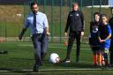 First Minister of Scotland Humza Yousaf plays football during a visit to a school holiday club at Ayr Academy