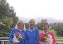 Ayr Seafield Ladies Golf club captain  Pat Palmer (pictured centre) hands MacDonald Quaich Club Championship winner Sheena Moore and runner up was Marjorie Errington bouquets
