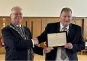 Allan Dorans MP presents Mac McCrostie from Ayr Burns Club with a copy of his Westminster early day motion