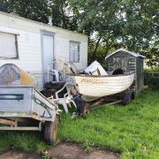 The woman's caravan barricaded with various objects.