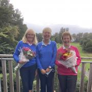 Ayr Seafield Ladies Golf club captain  Pat Palmer (pictured centre) hands MacDonald Quaich Club Championship winner Sheena Moore and runner up was Marjorie Errington bouquets
