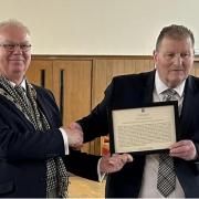 Allan Dorans MP presents Mac McCrostie from Ayr Burns Club with a copy of his Westminster early day motion