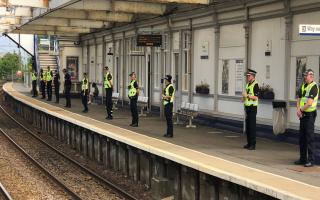 Officers await incoming trains at Troon station